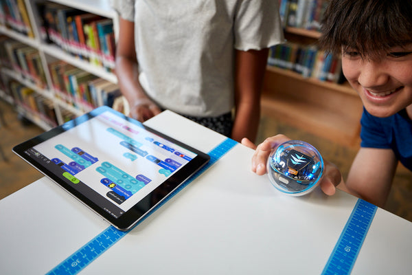 A student prepares to run code from an ipad on their BOLT+.