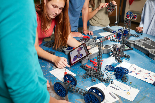 A group of high school students work on an engineering project with Sphero Blueprint.
