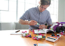 Educator reading instructions and putting littleBits invention together.