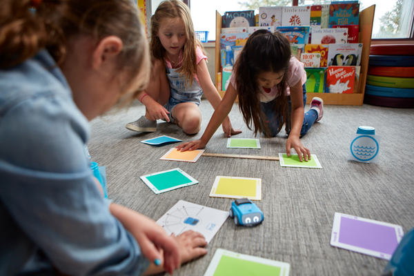 Three students create a path for indi.